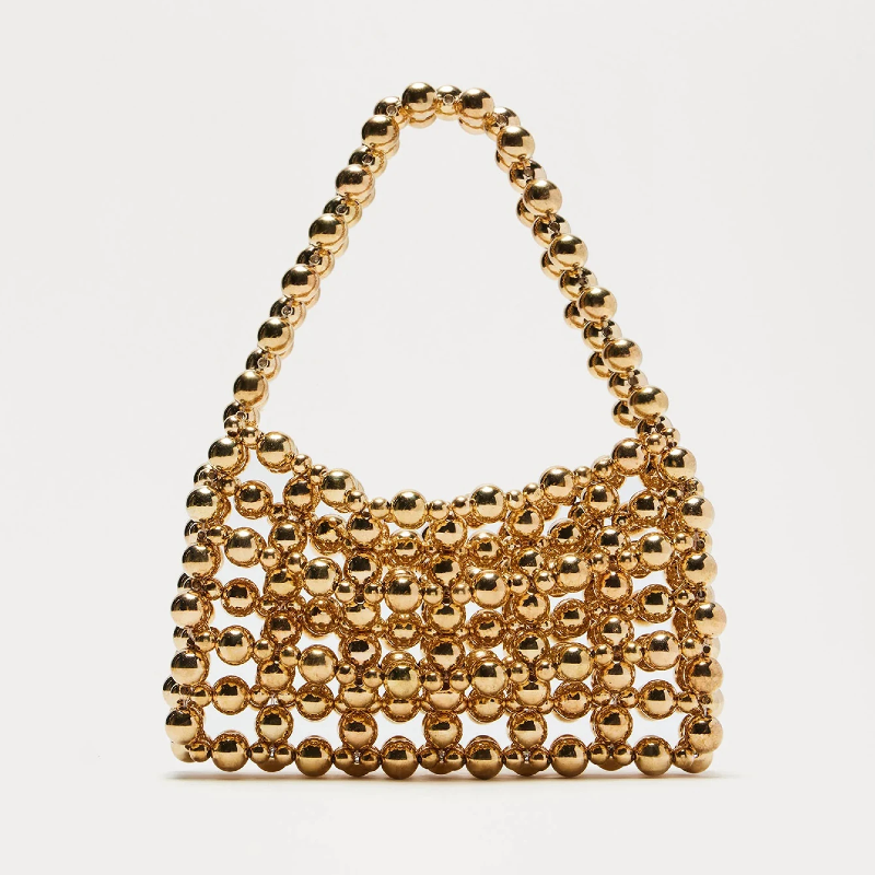 Gold beaded handbag on a white background