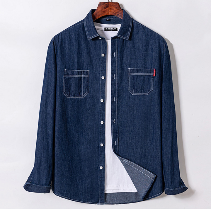 Blue denim shirt on a hanger against a white background