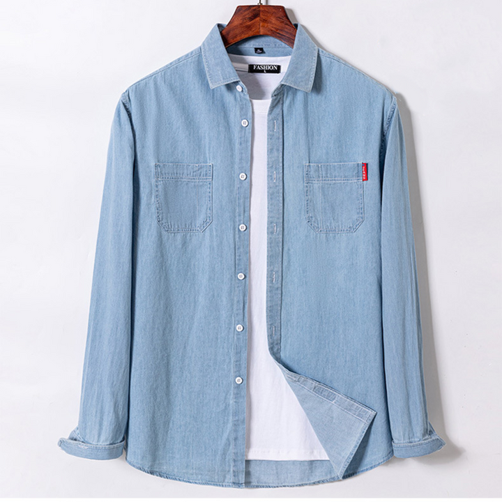 Light blue denim shirt on a hanger against a white background