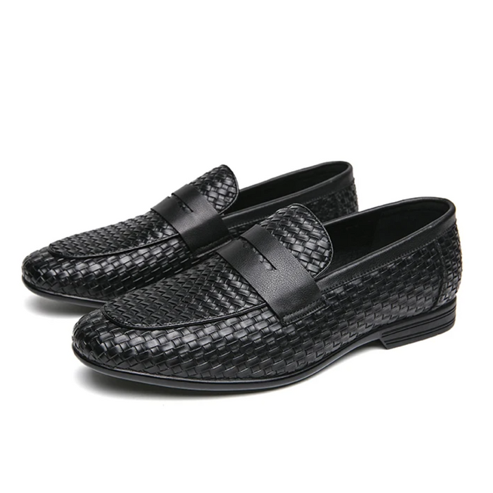 Black woven loafers on a white background