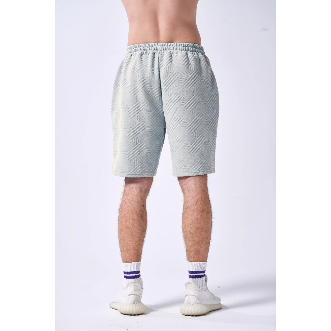 Light gray shorts worn by a person on a white background