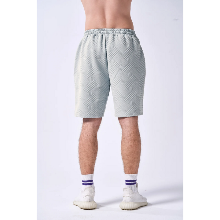 Light gray shorts worn by a person on a white background