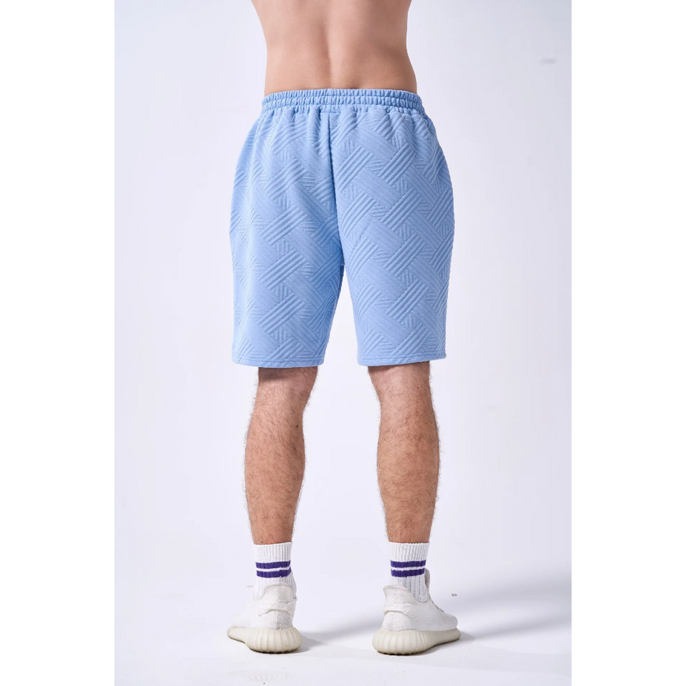 Light blue shorts worn by a person on a white background