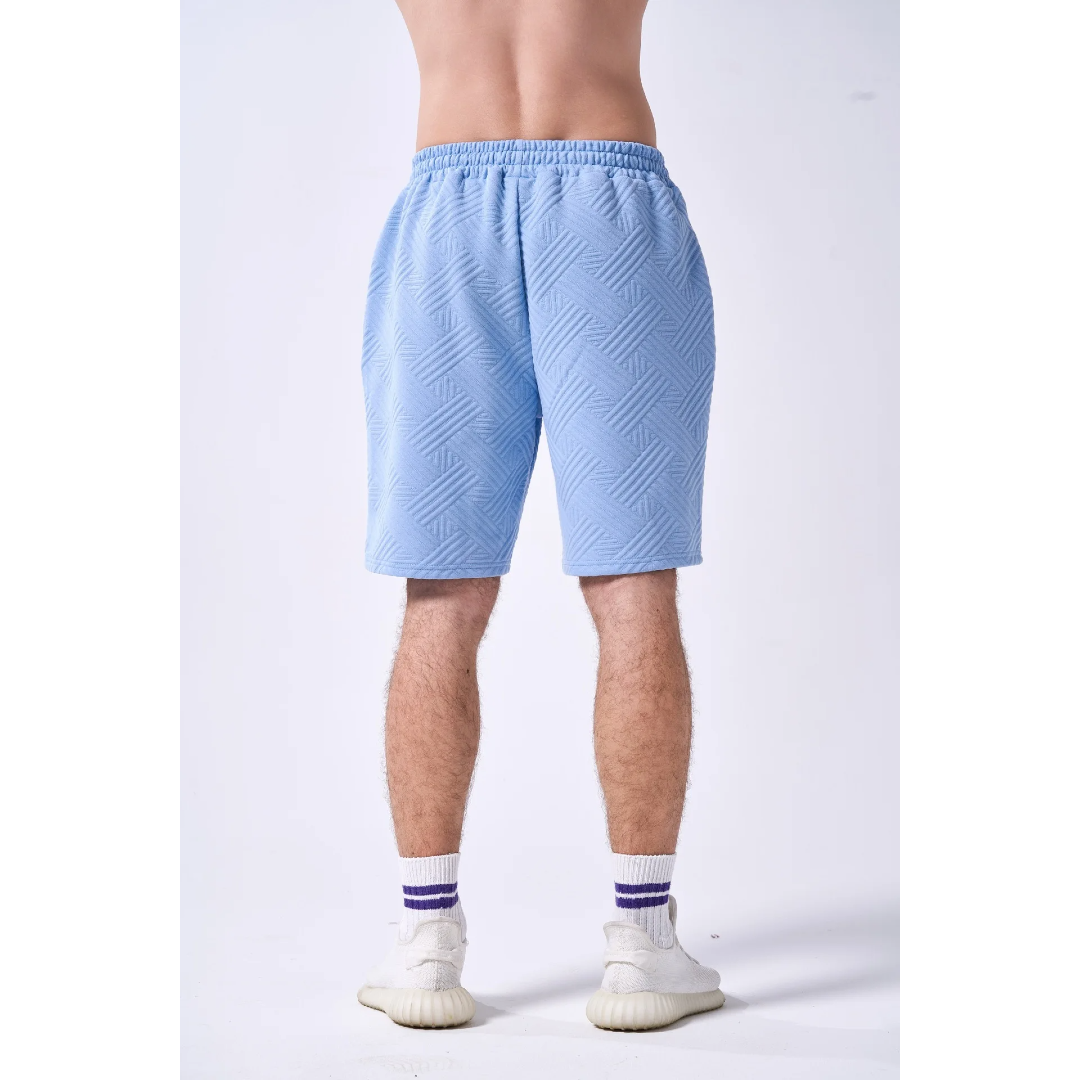 Light blue shorts worn by a person on a white background