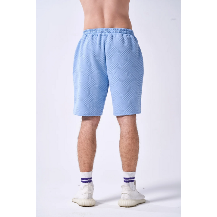 Light blue shorts worn by a person on a white background
