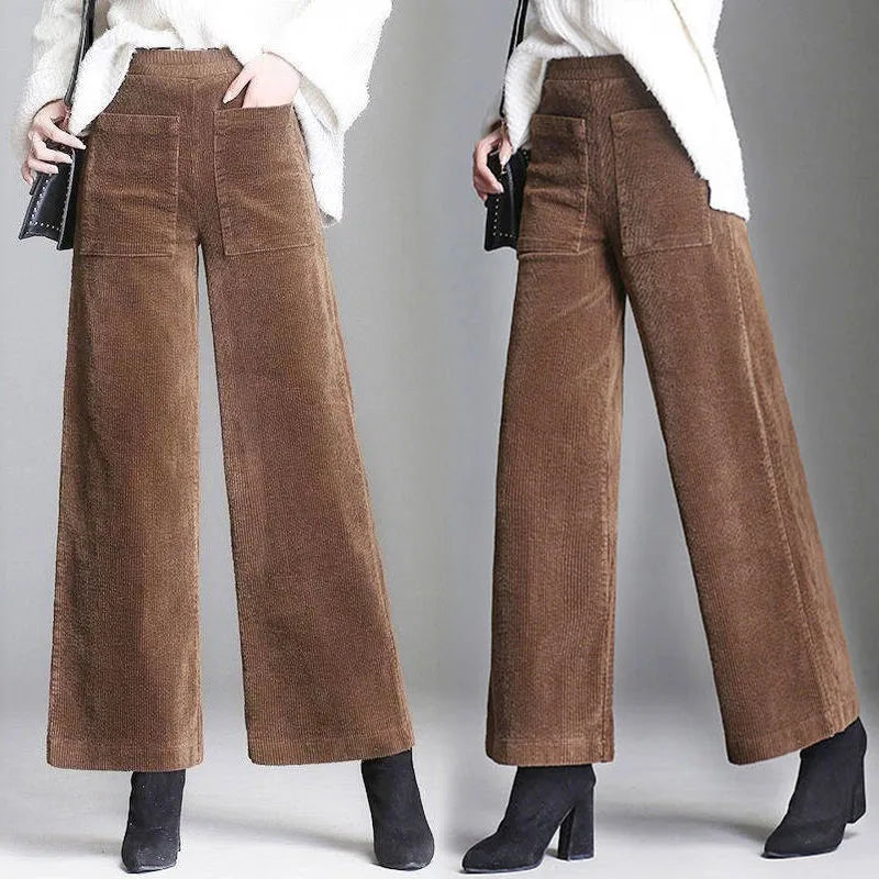 Brown wide-leg pants worn by a person on a gray background