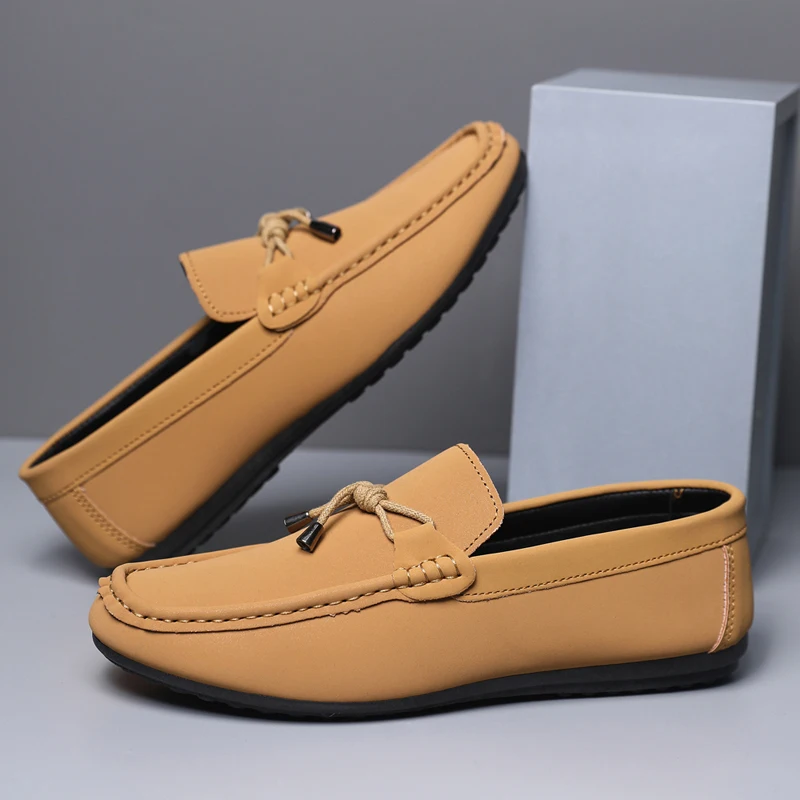 Pair of tan loafers on a gray background