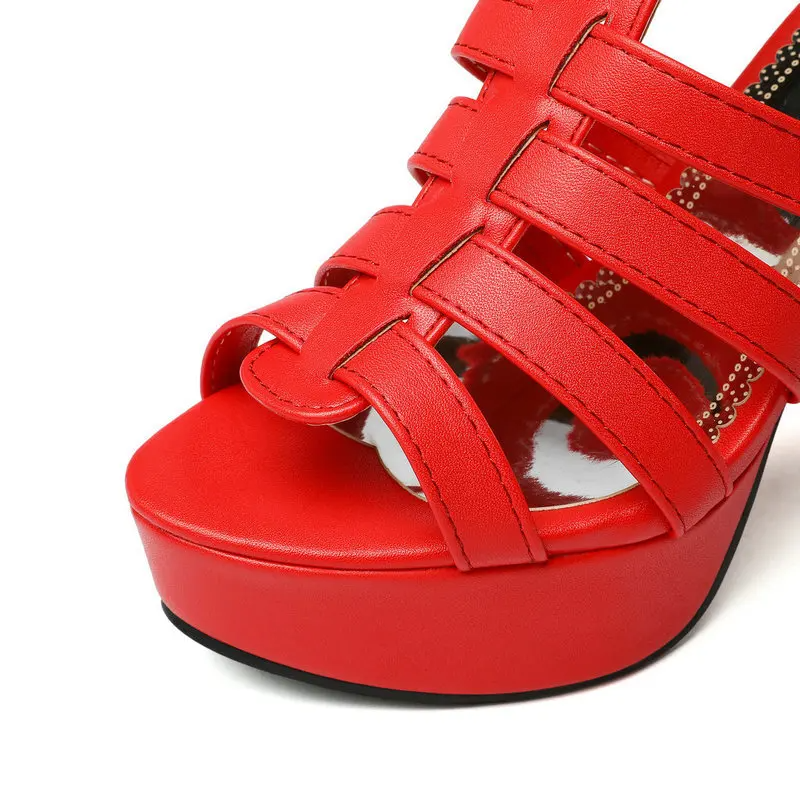 Red platform sandal with multiple straps on a white background