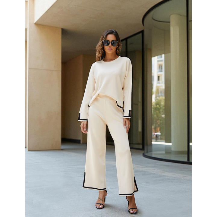 Woman in a stylish outfit standing in front of a modern building.