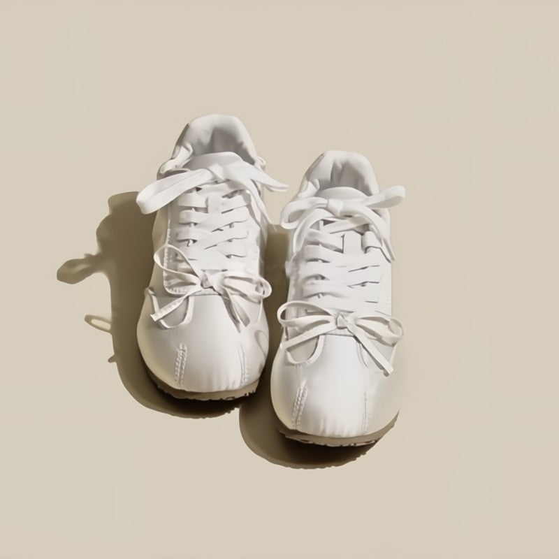 Pair of white sneakers on a beige background