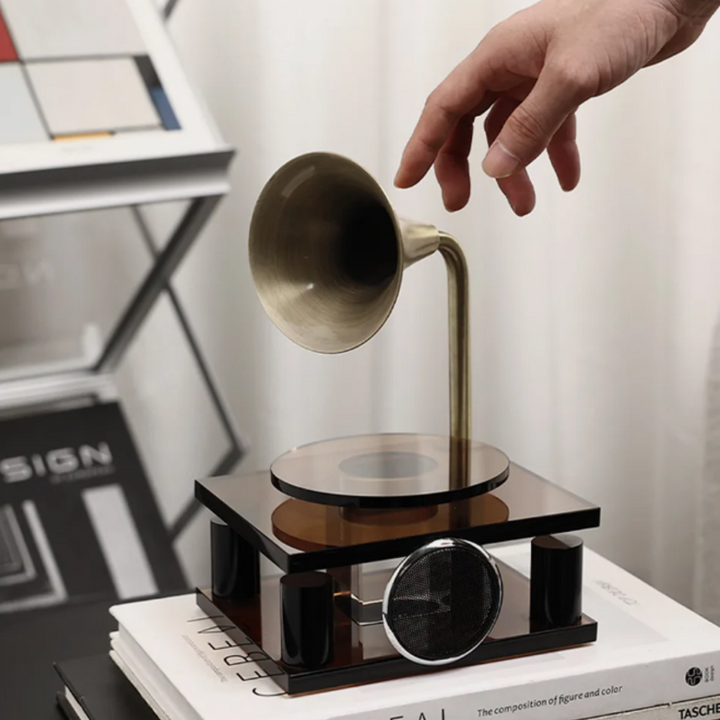 Levitating cup device on a table with a hand reaching towards it