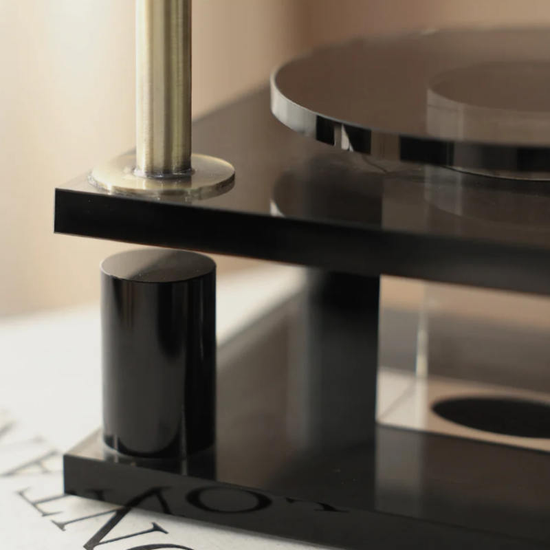 Close-up of a modern black and silver faucet on a bathroom sink.