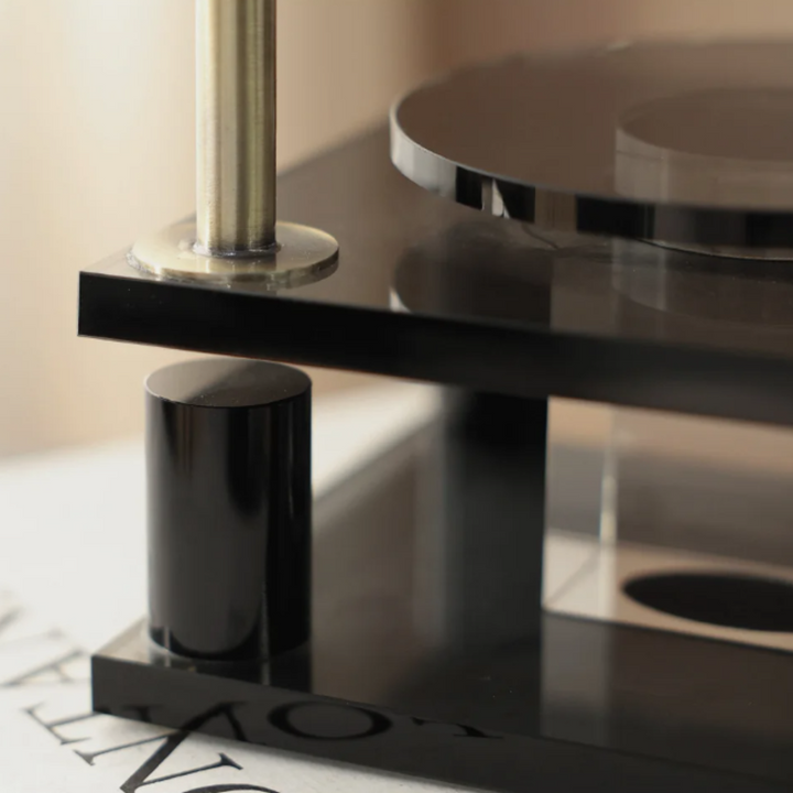 Close-up of a modern black and silver faucet on a bathroom sink.