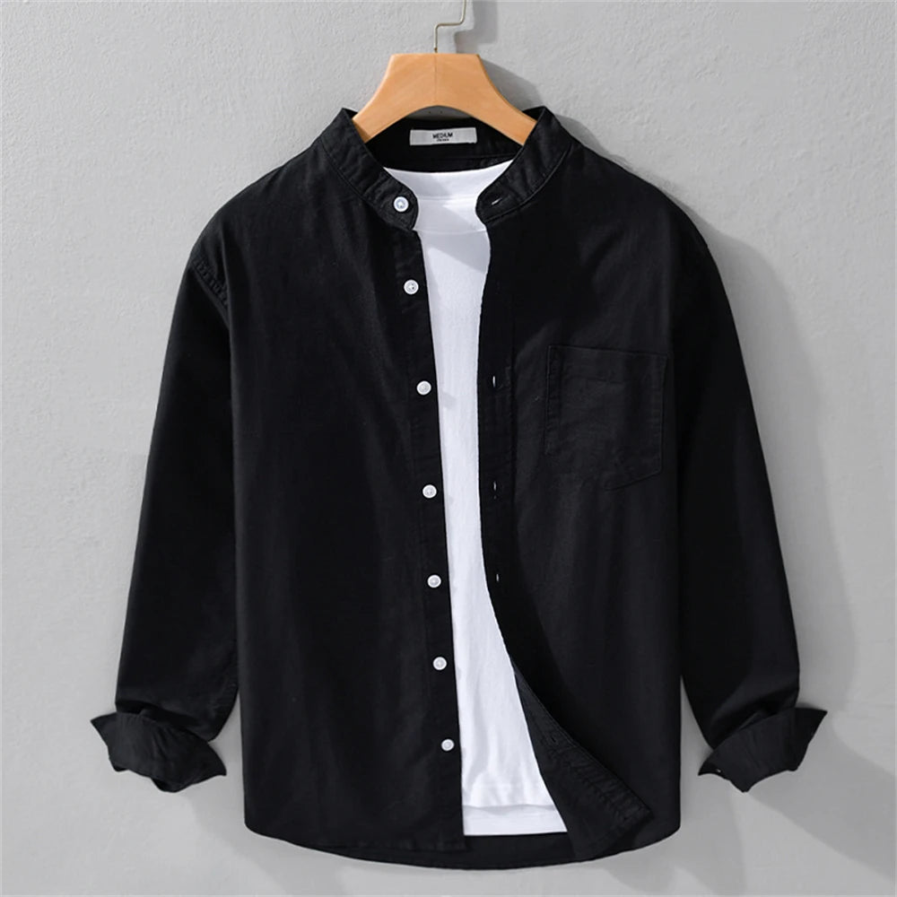 Black button-up shirt with white undershirt on a hanger against a gray background