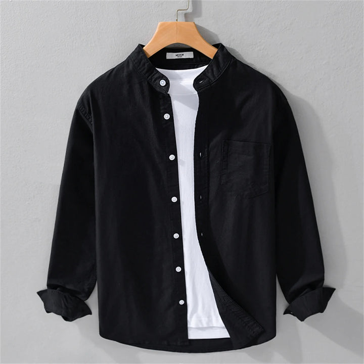 Black button-up shirt with white undershirt on a hanger against a gray background