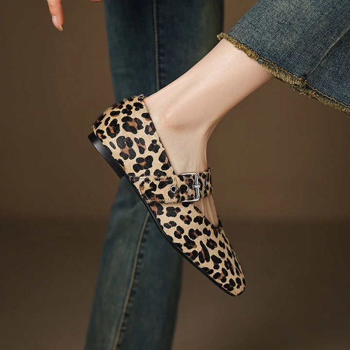 Leopard print shoe with a buckle on a blurred background