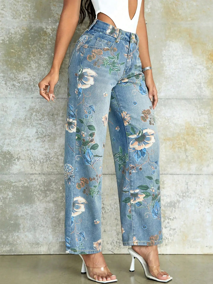 Floral-patterned jeans worn by a person against a textured wall.