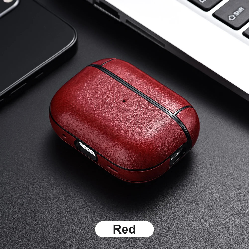 Red leather case on a dark surface with a phone and laptop in the background