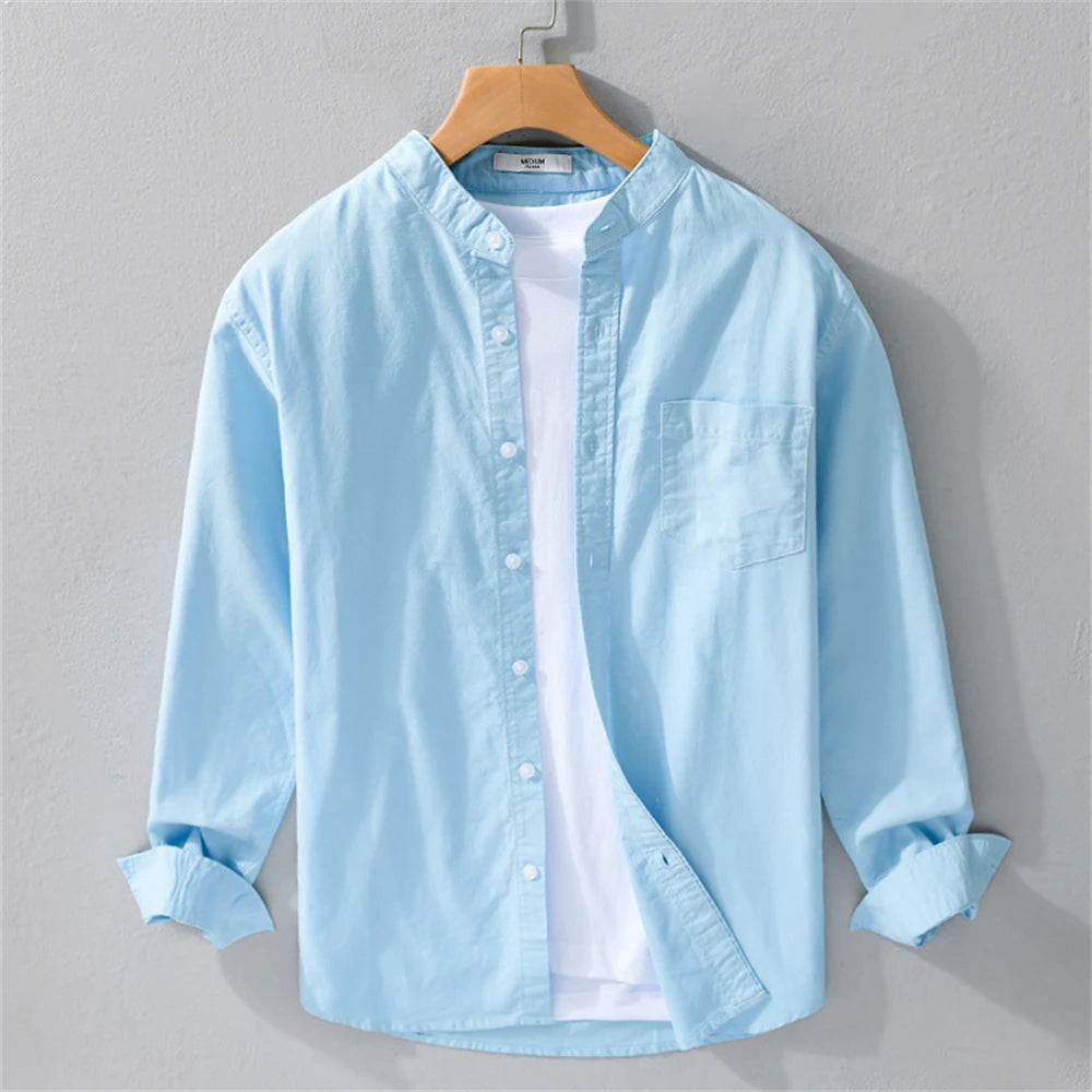 Light blue shirt on a hanger against a gray background