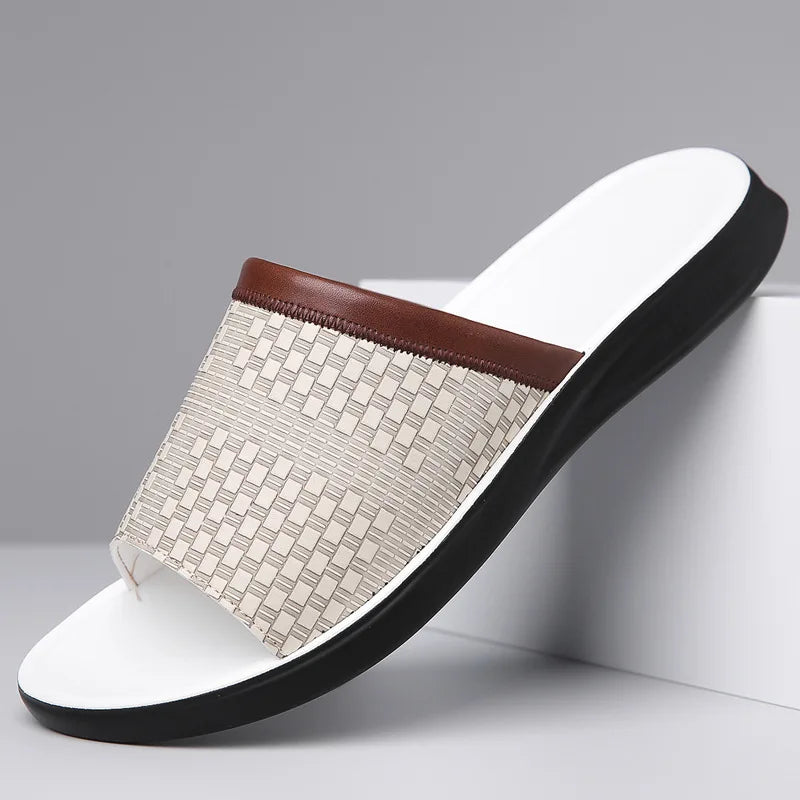 Slipper with woven pattern and white sole on a gray background