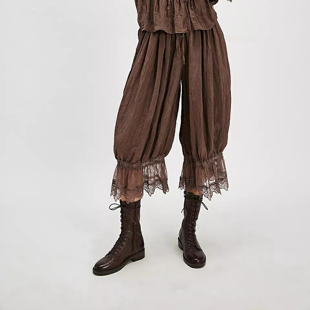 Brown lace-trimmed pants with matching boots on a white background