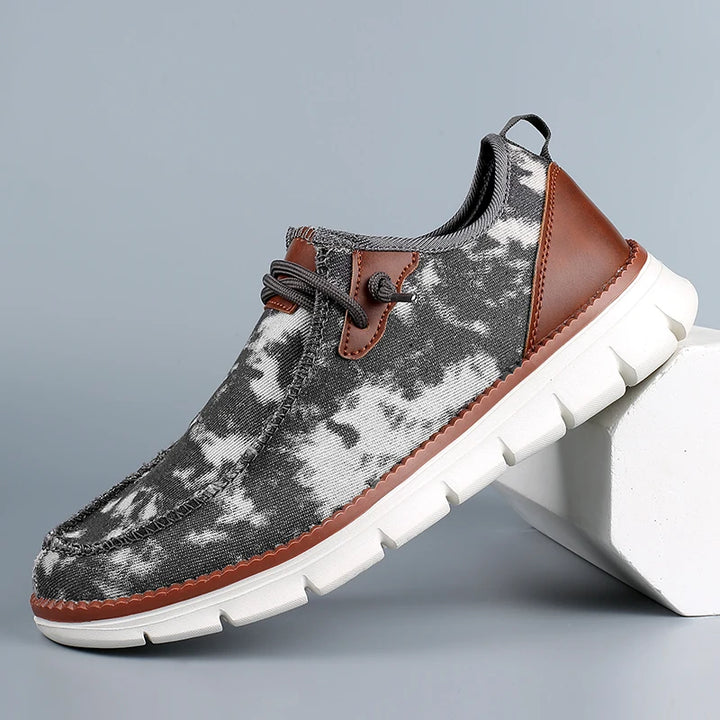 Gray camouflage shoe with brown accents on a gray background