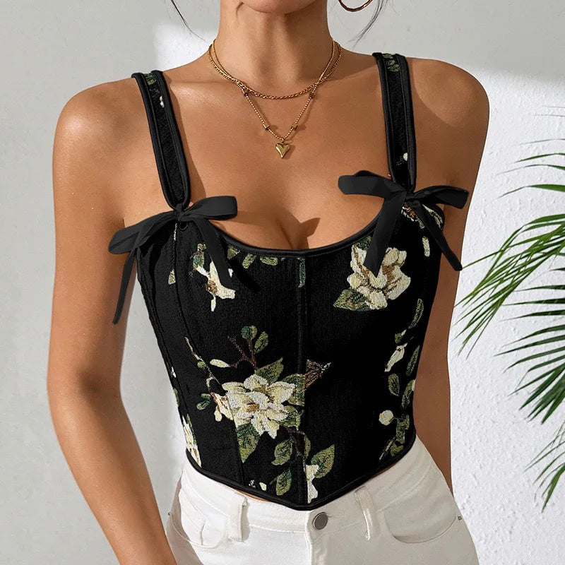 Black floral corset top worn by a person with a white background