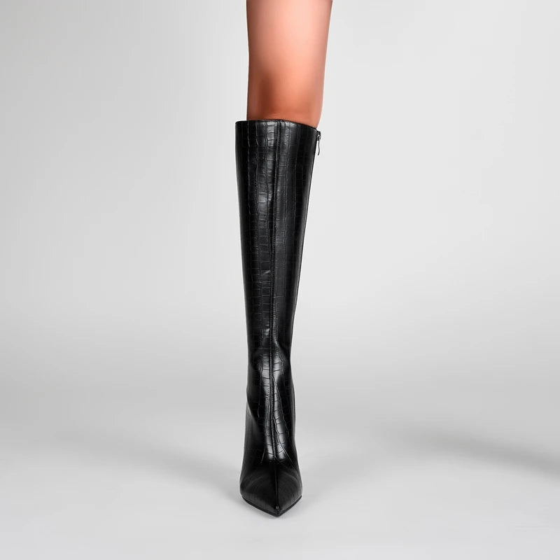 Black knee-high boot on a gray background