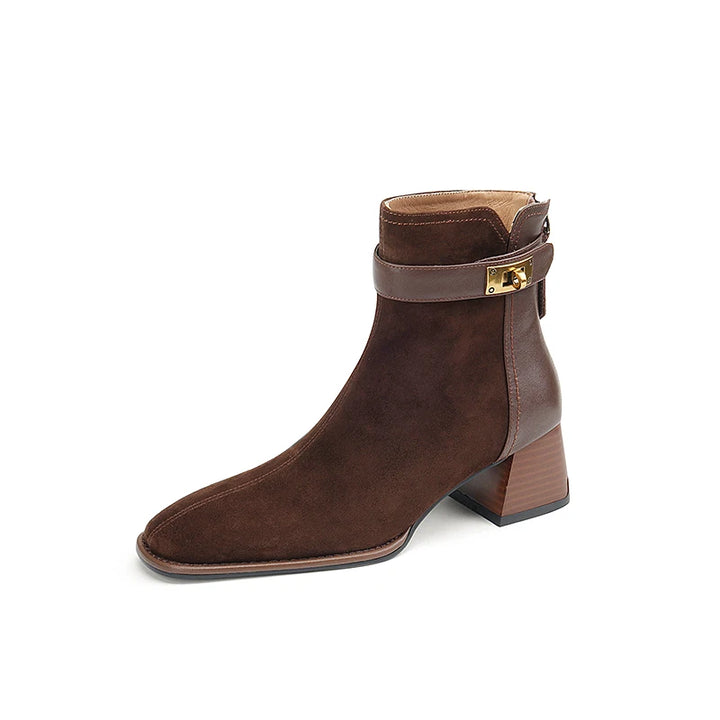 Brown ankle boot with a gold buckle on a white background