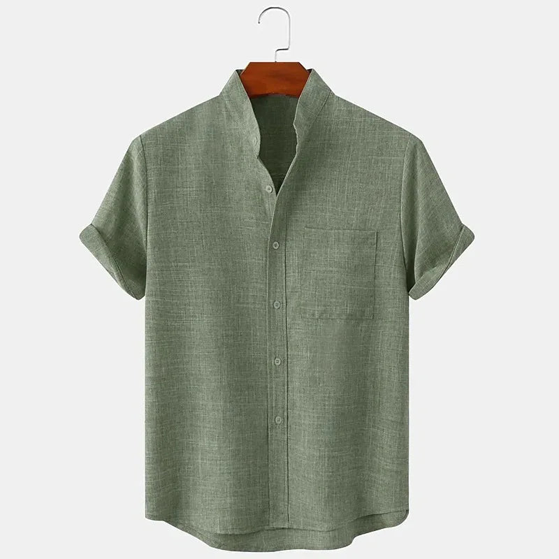 Green short-sleeve shirt on a hanger against a white background
