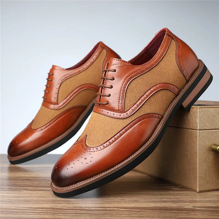 Brown and beige dress shoes on a wooden surface with a neutral background