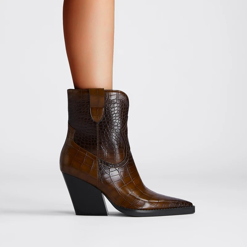 Brown crocodile-patterned ankle boot on a mannequin leg against a light gray background