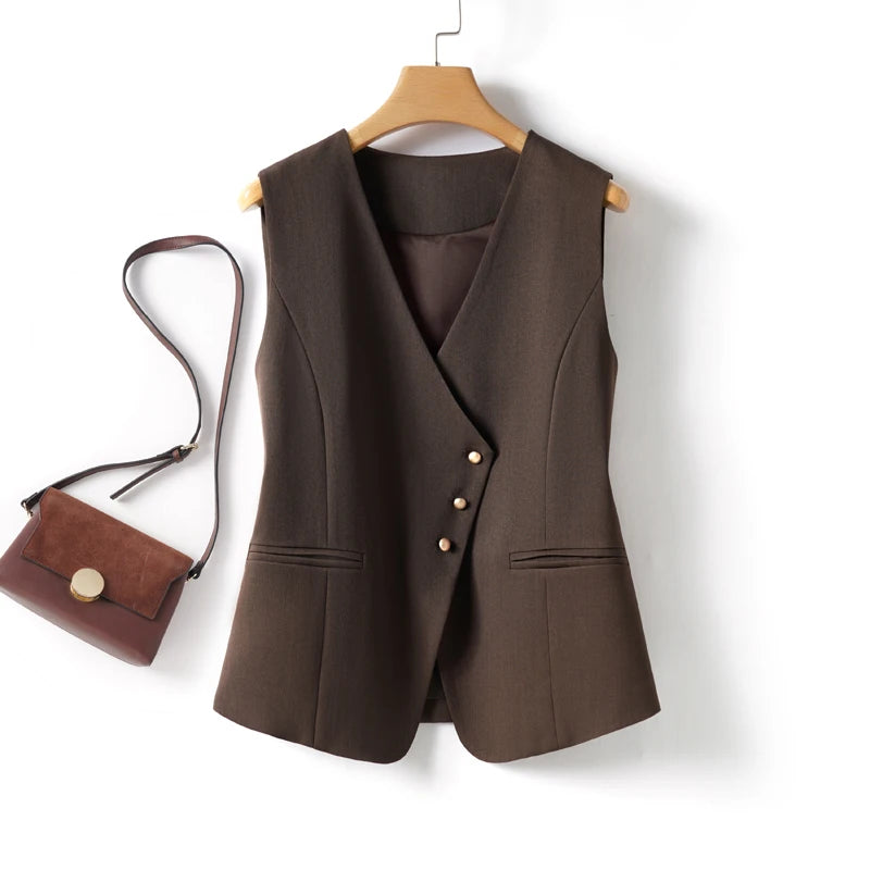Brown vest on a hanger with a matching handbag on a white background