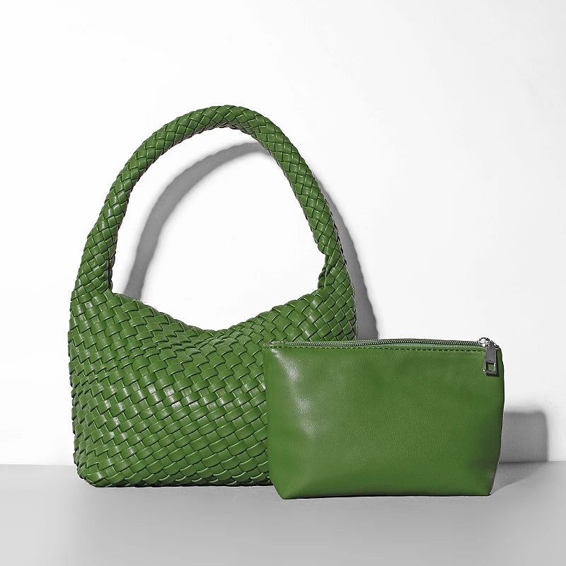 Green woven handbag and matching pouch on a white background