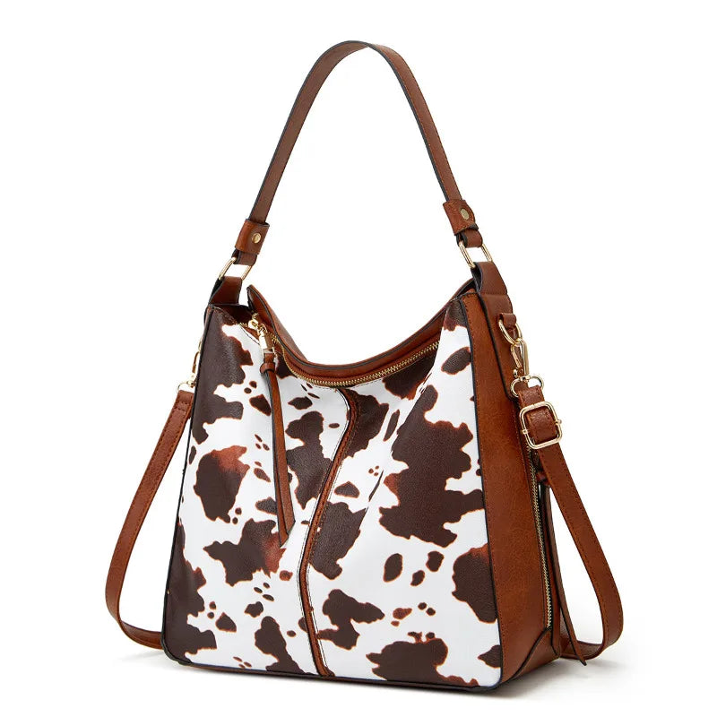 Handbag with cow print pattern on a white background