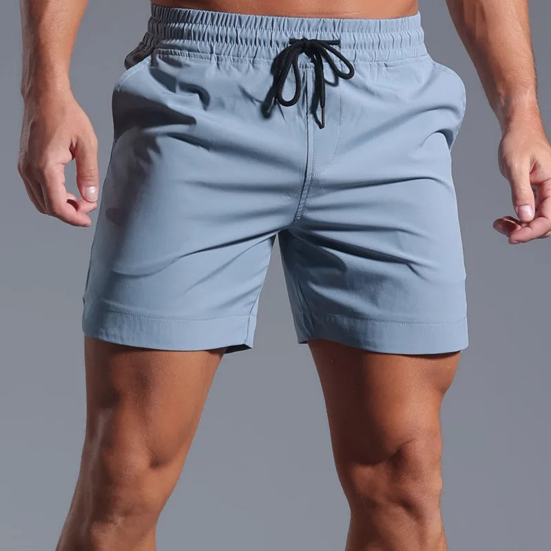 Light blue shorts with a drawstring on a gray background