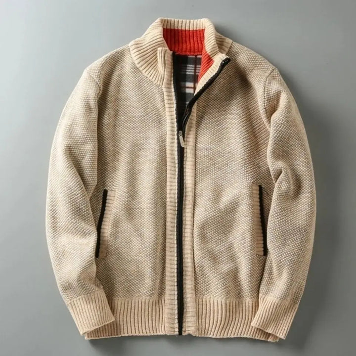 Beige knitted jacket with a plaid lining on a gray background