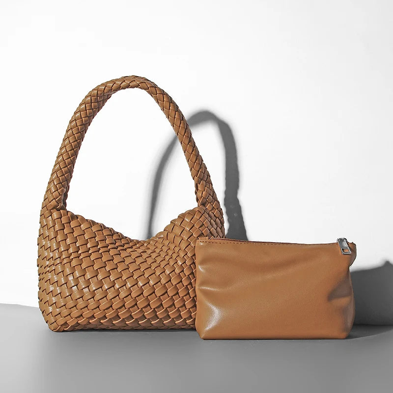 Brown woven handbag and matching pouch on a light gray background