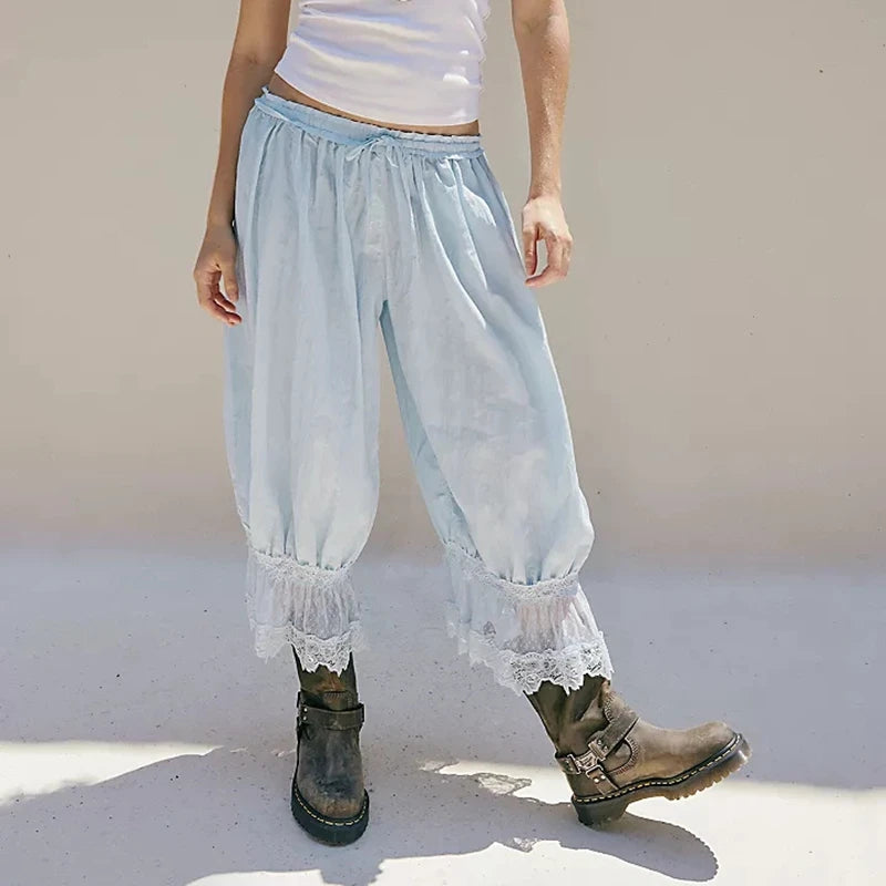 Light blue lace-trimmed pants worn by a person on a plain background