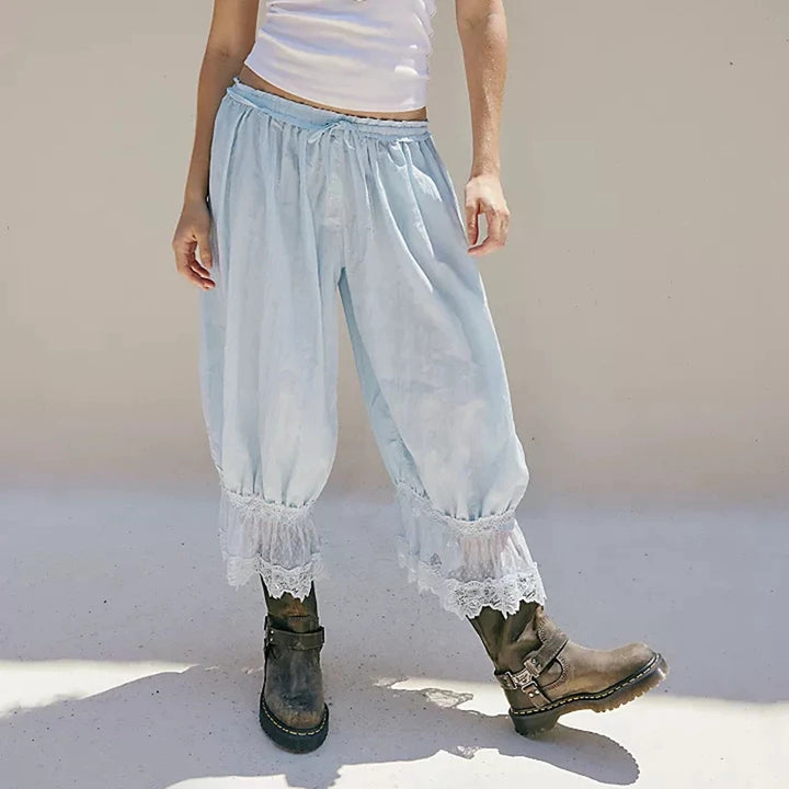 Light blue lace-trimmed pants worn by a person on a plain background