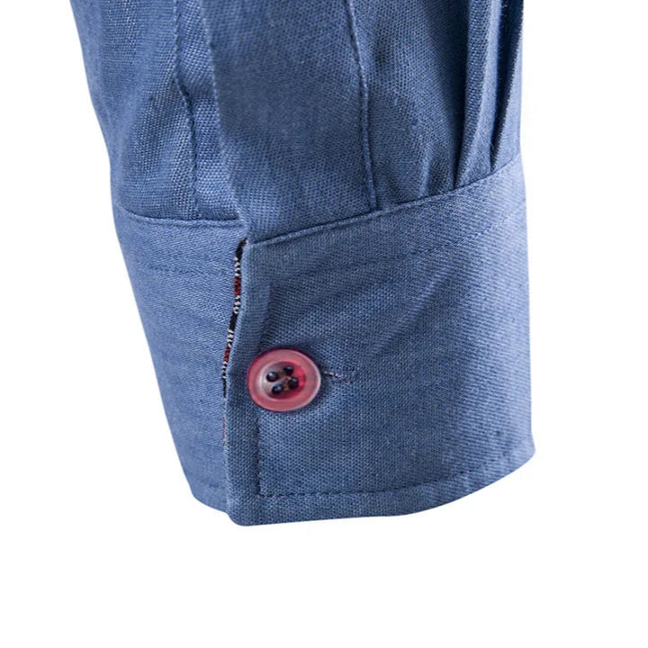 Close-up of a blue fabric with a button on a white background