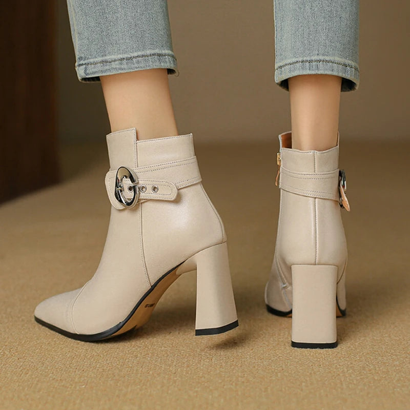 Beige ankle boots with block heels on a beige background