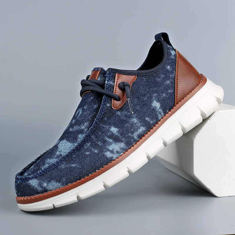 Blue denim shoe with brown accents on a gray background