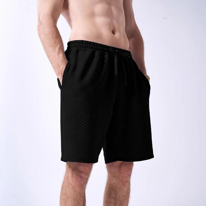 Black shorts worn by a person on a white background