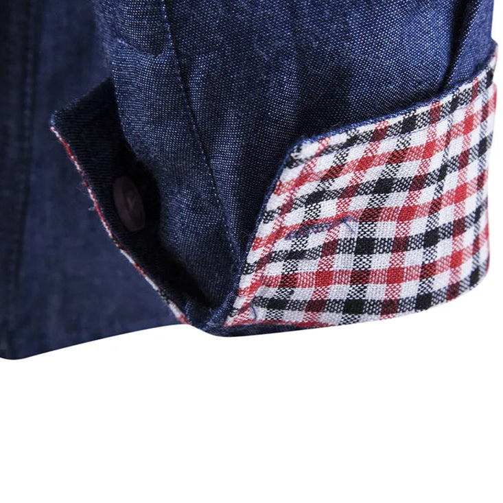 Close-up of a navy blue fabric with a red, white, and black checkered trim on a white background