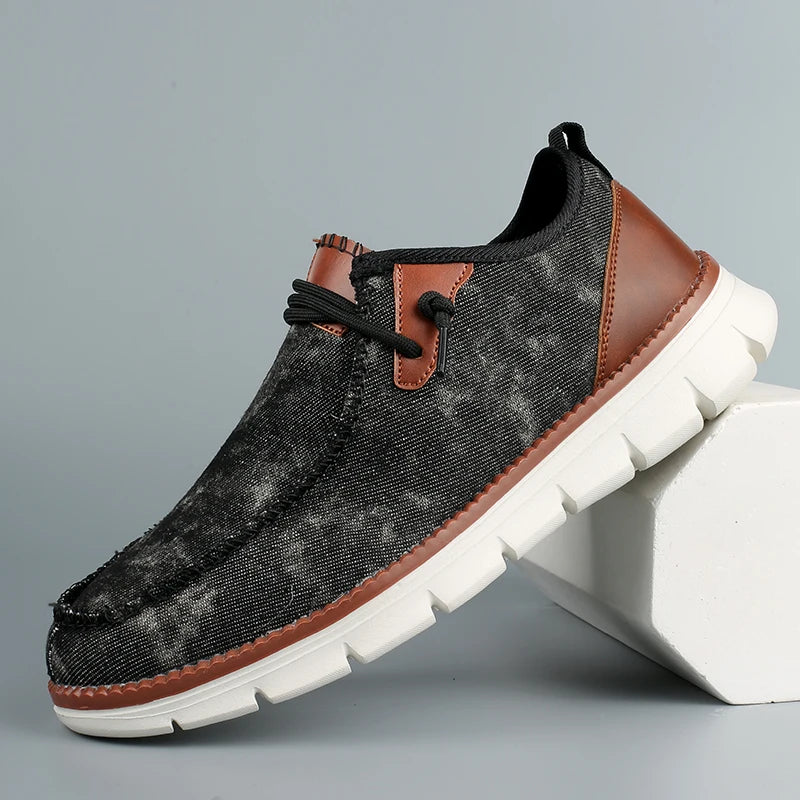 Black and brown casual shoe with white sole on a gray background