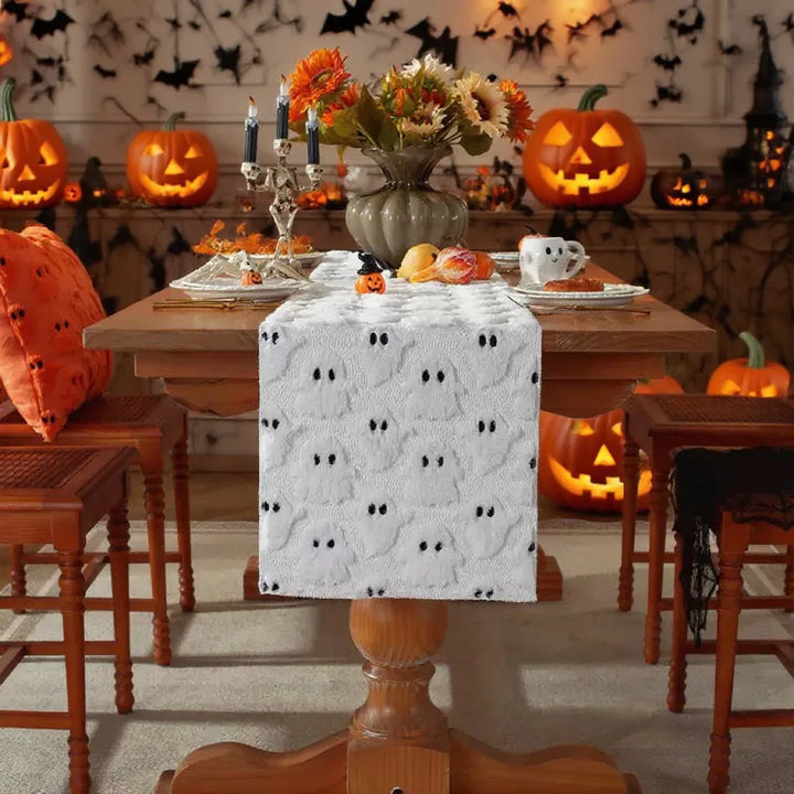 Halloween-themed dining room with pumpkins, a tablecloth, and decorative elements.