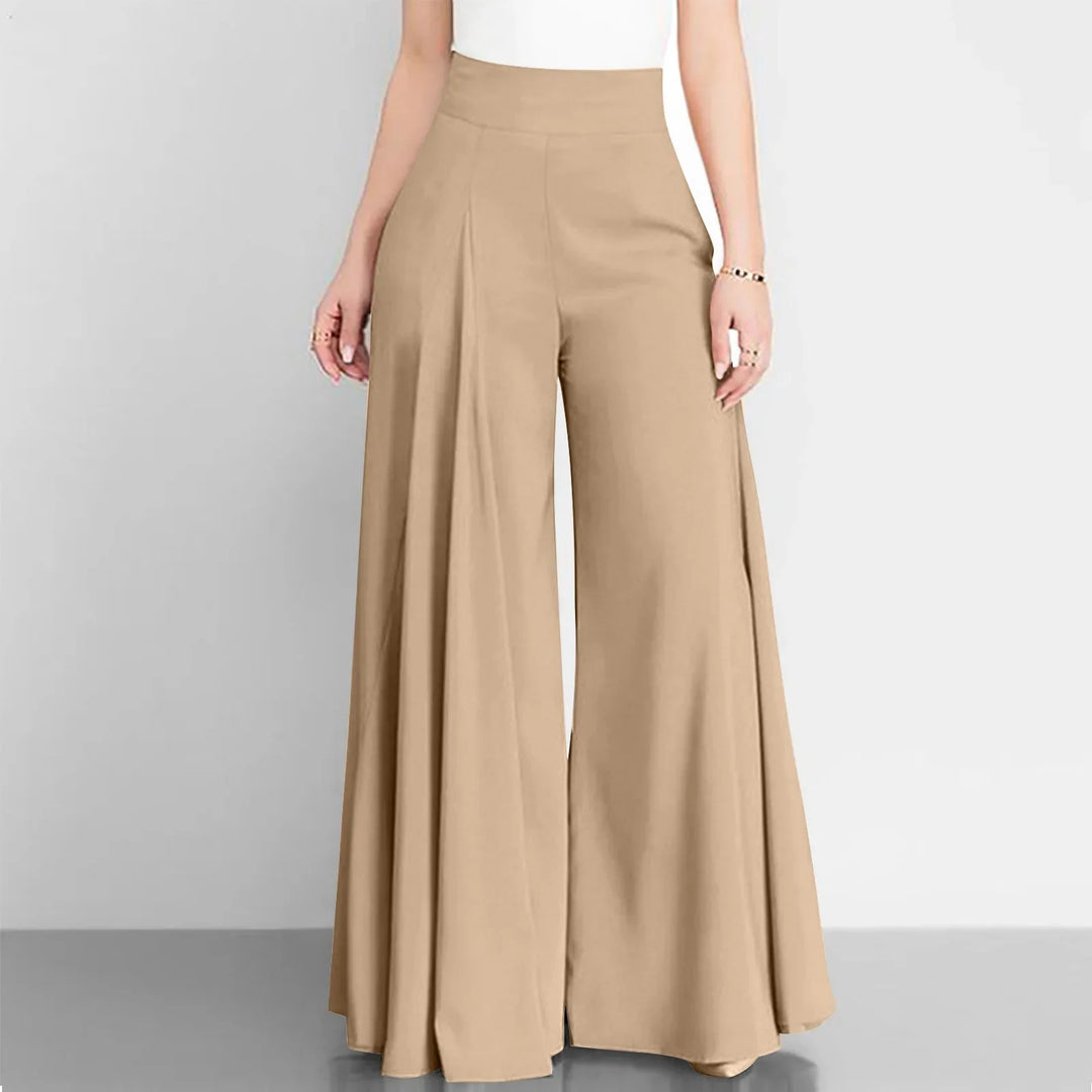 Beige wide-leg pants worn by a person on a gray background