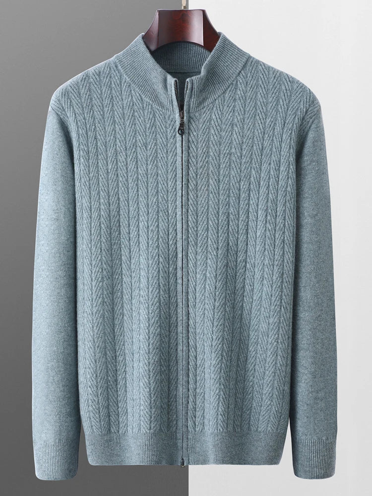 Gray zip-up sweater on a hanger against a gray background