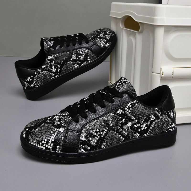Black and silver sequin sneakers on a gray surface with a white box in the background.